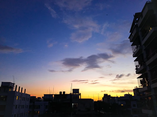 A crisp, vibrant photo of a city skyline at dusk with navy blue and charcoal tones.