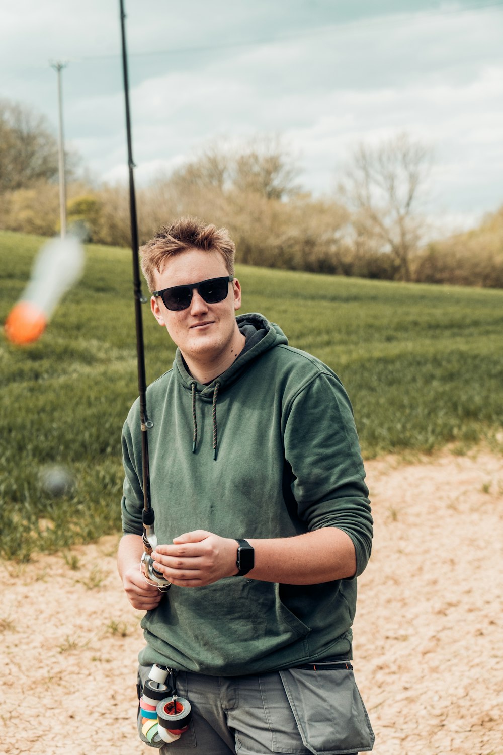 a man holding a fishing pole