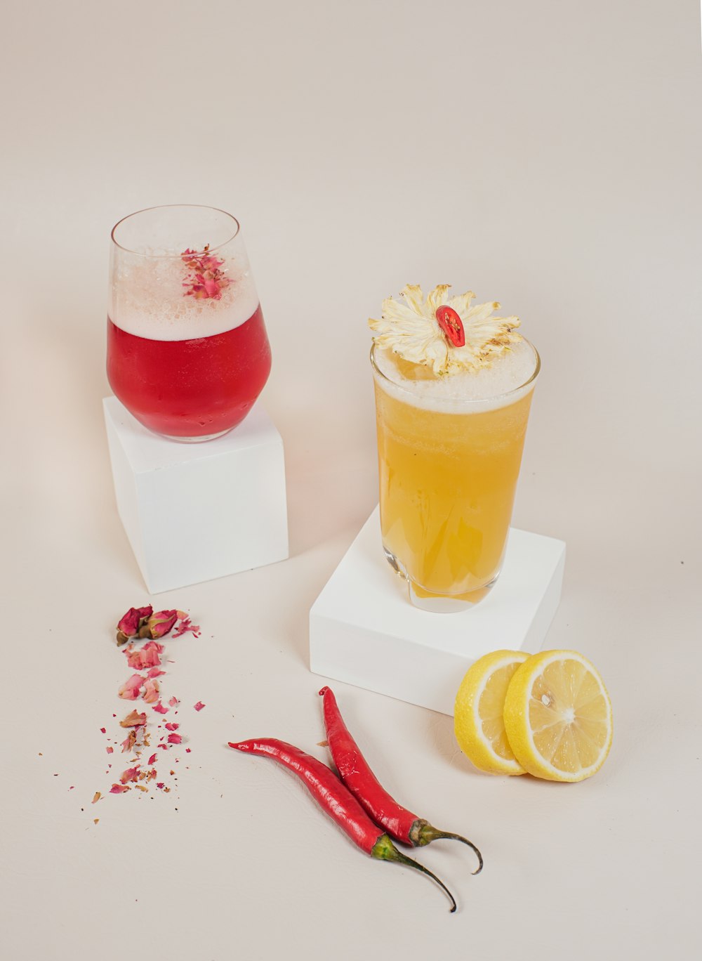 a group of glasses with liquid and fruit in them