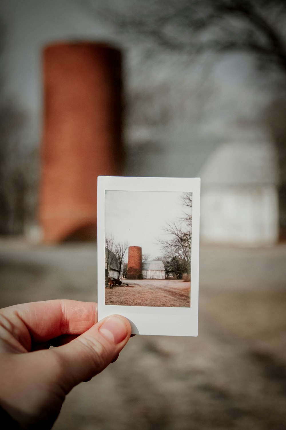 a hand holding a picture of a house