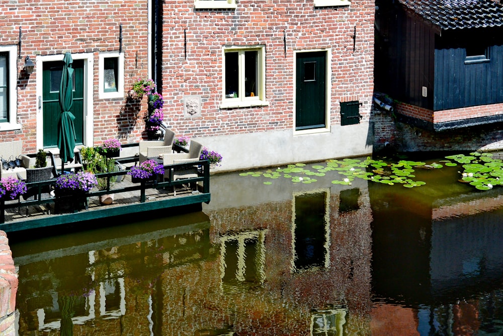 a brick building with a pool of water in front of it