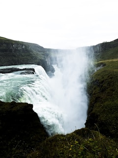 a waterfall with a rainbow