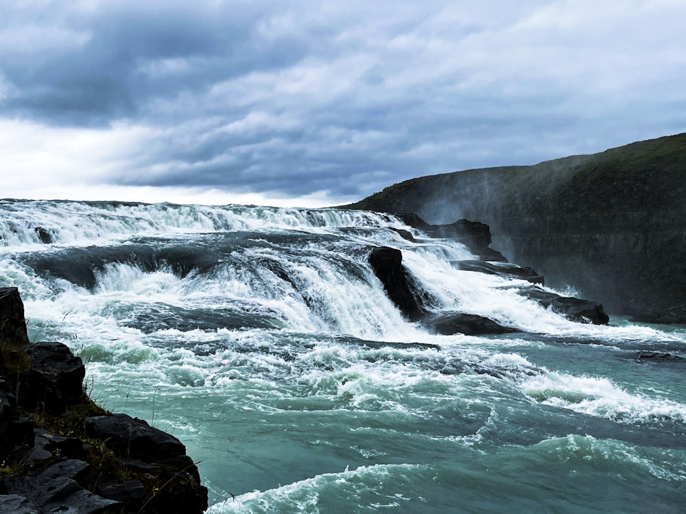 a rocky beach with waves crashing against the shore