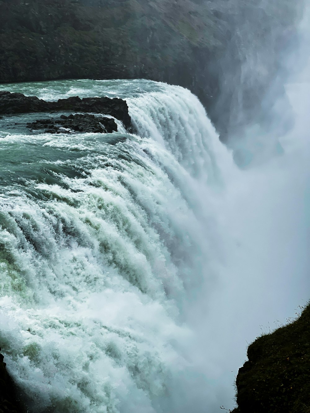 a large waterfall with rocks