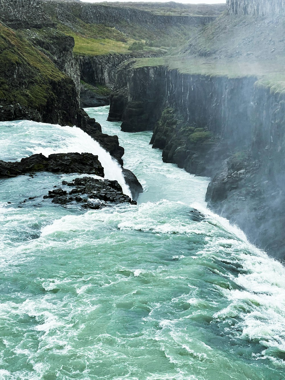 a river flowing between rocky cliffs