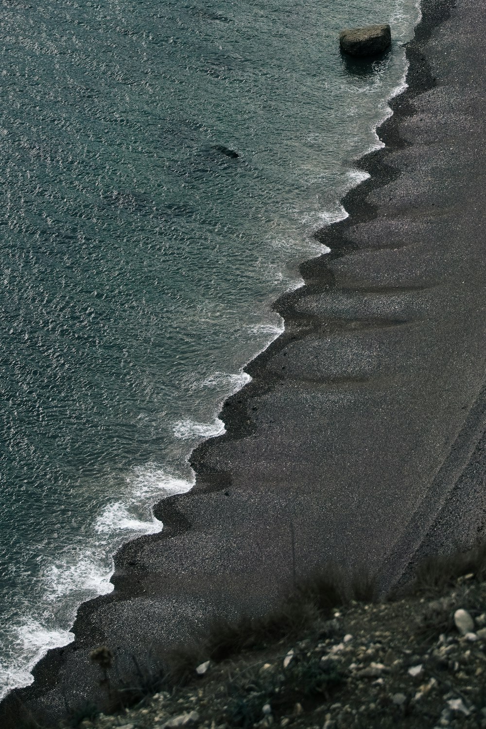 a beach with rocks and a body of water