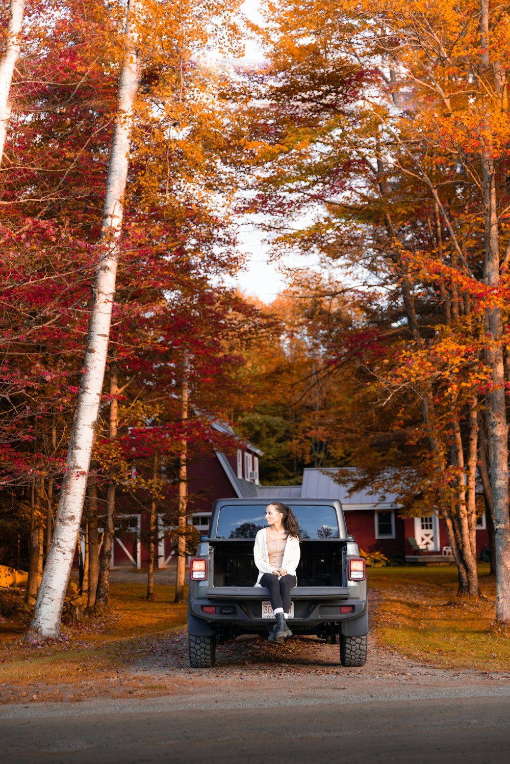 a person sitting on the back of a truck in a neighborhood