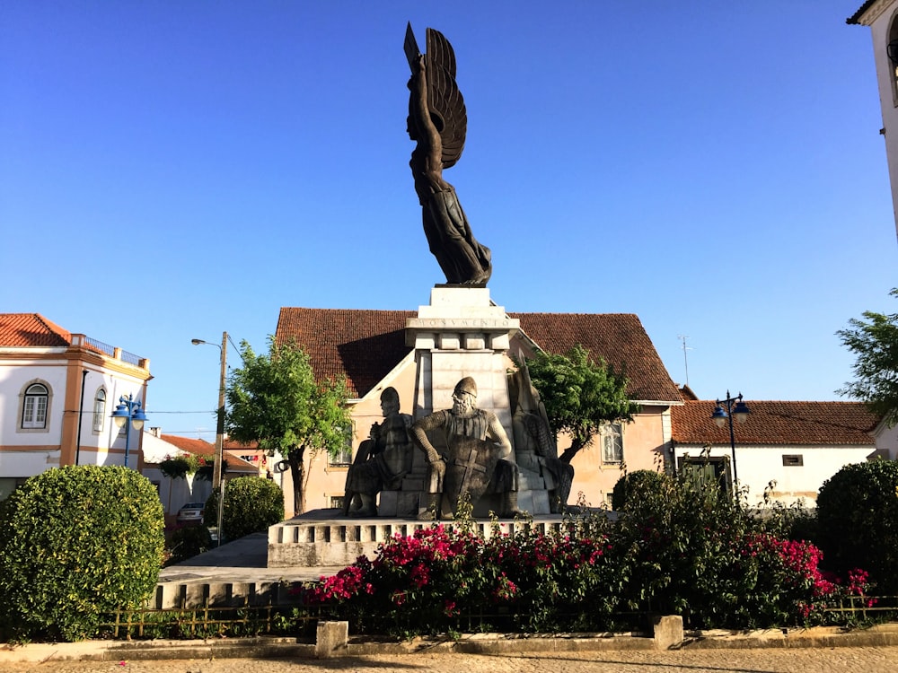 a statue of a person holding a staff