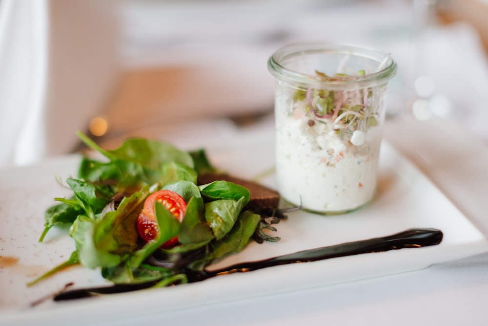 a plate of salad and a glass of milk