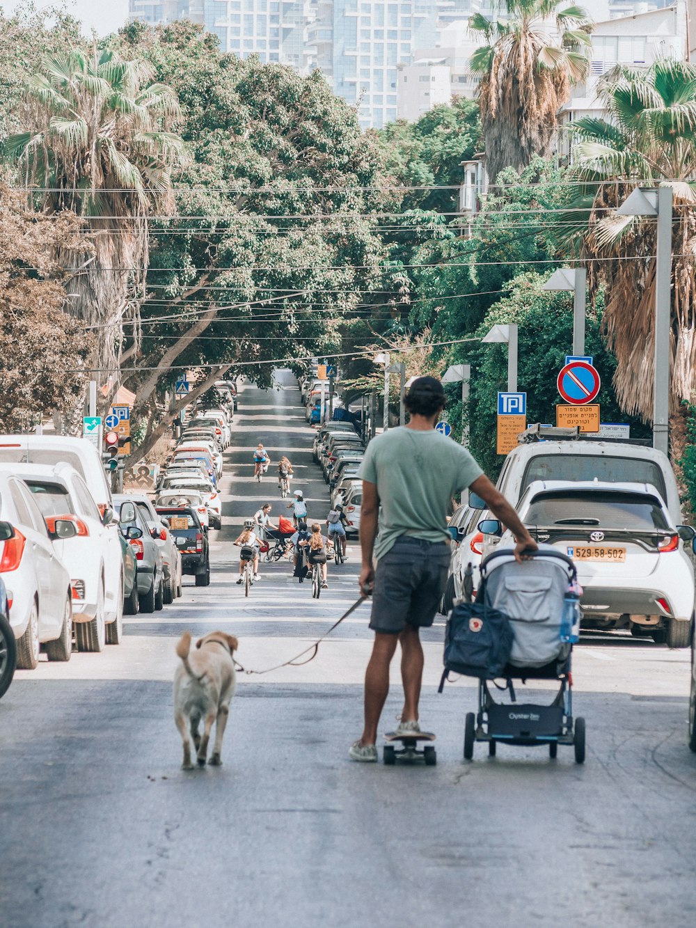 a man with a dog on a skateboard in a busy street