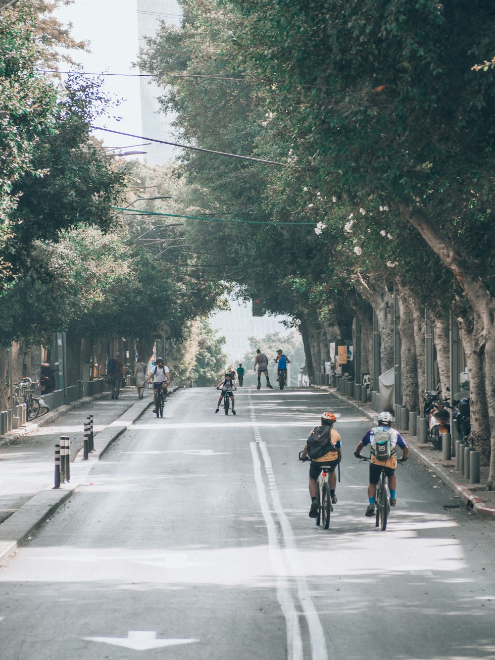 a group of bicyclists going down a street