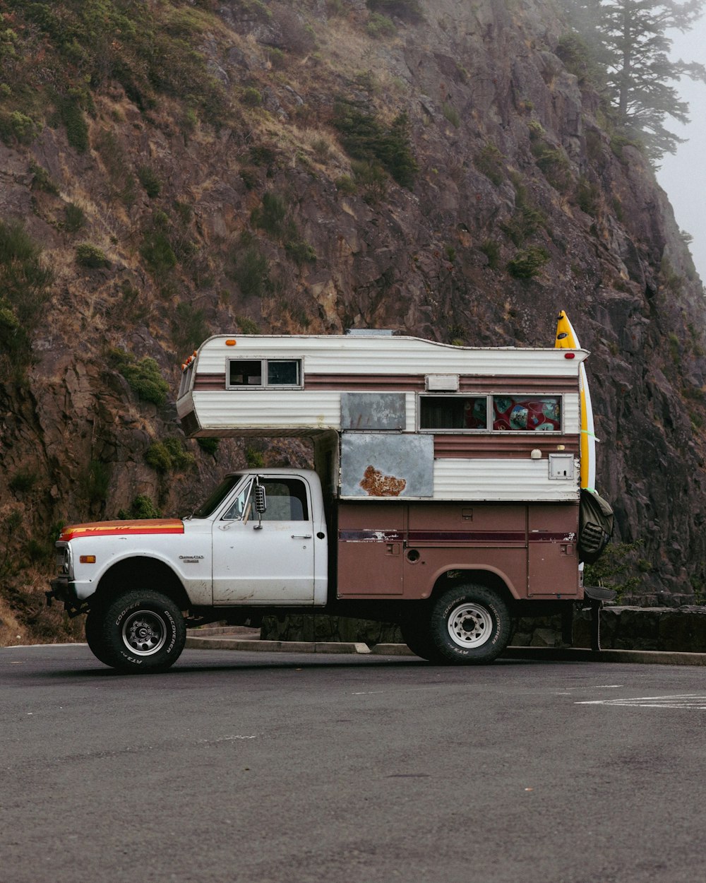 a truck parked in front of a cliff