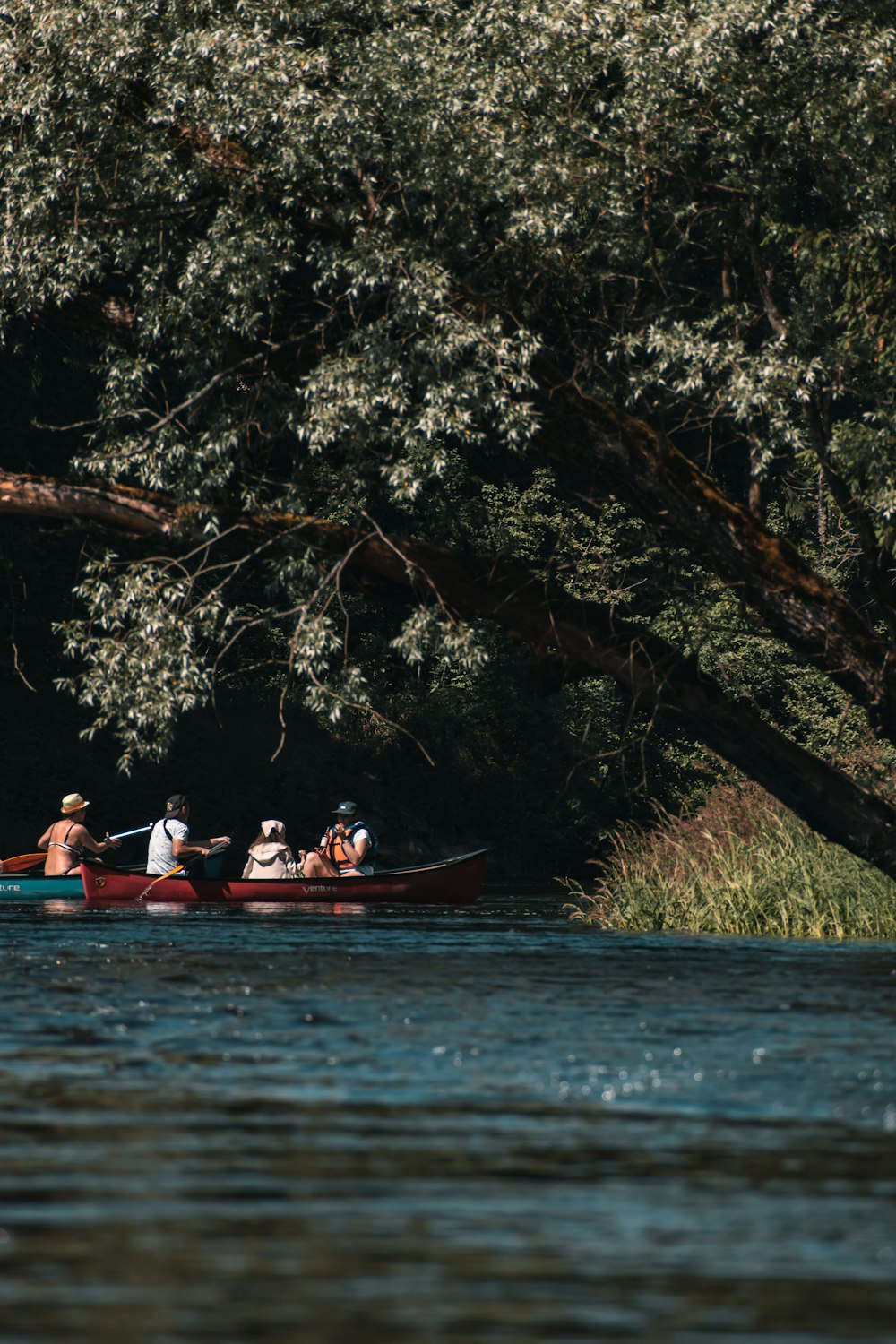 a group of people in a canoe on a river