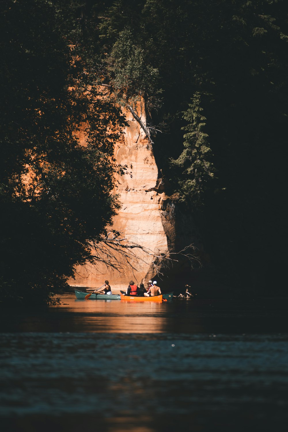 a group of people in a boat under a large arch