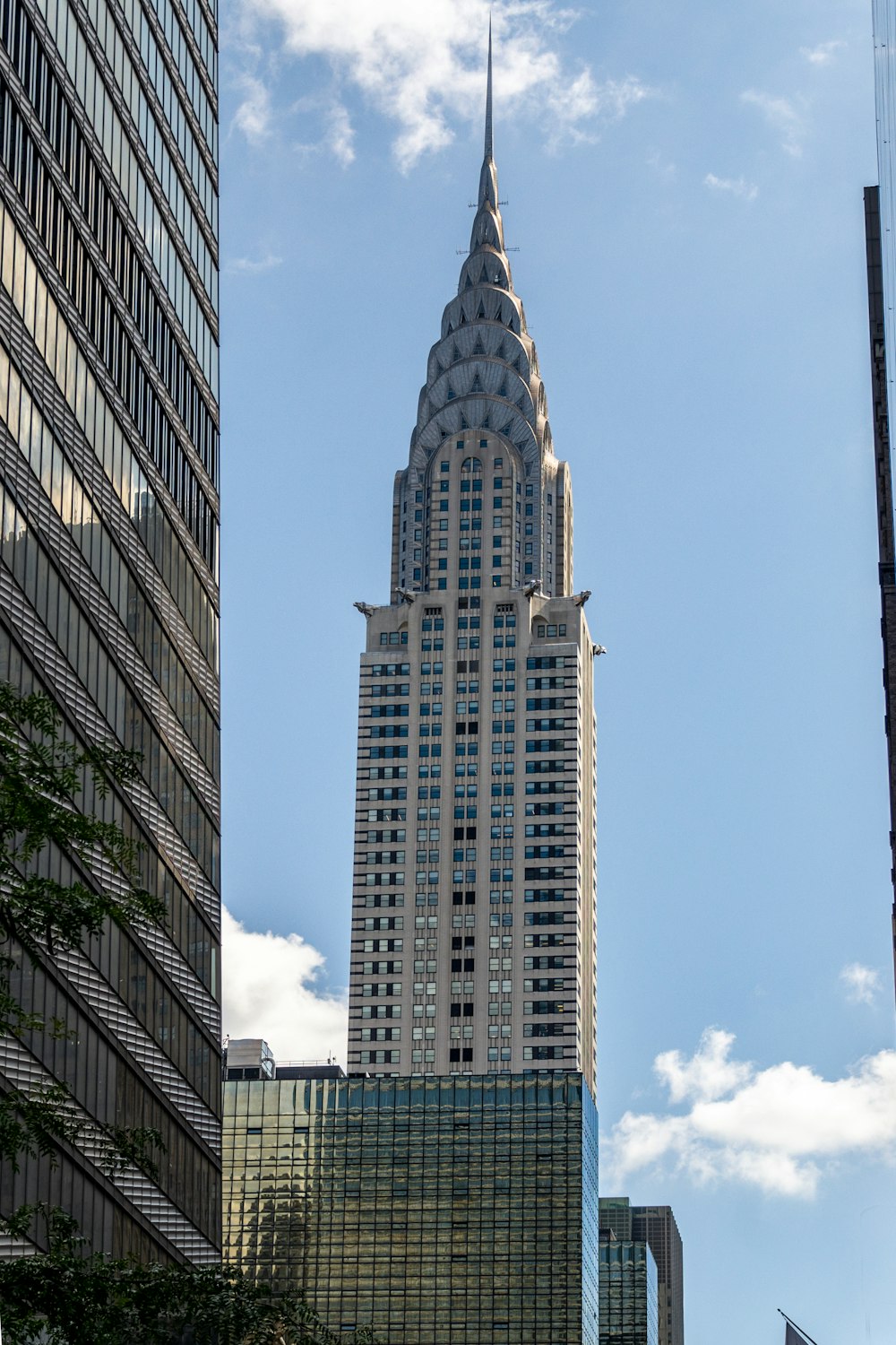 a tall building with a pointy top with Chrysler Building in the background