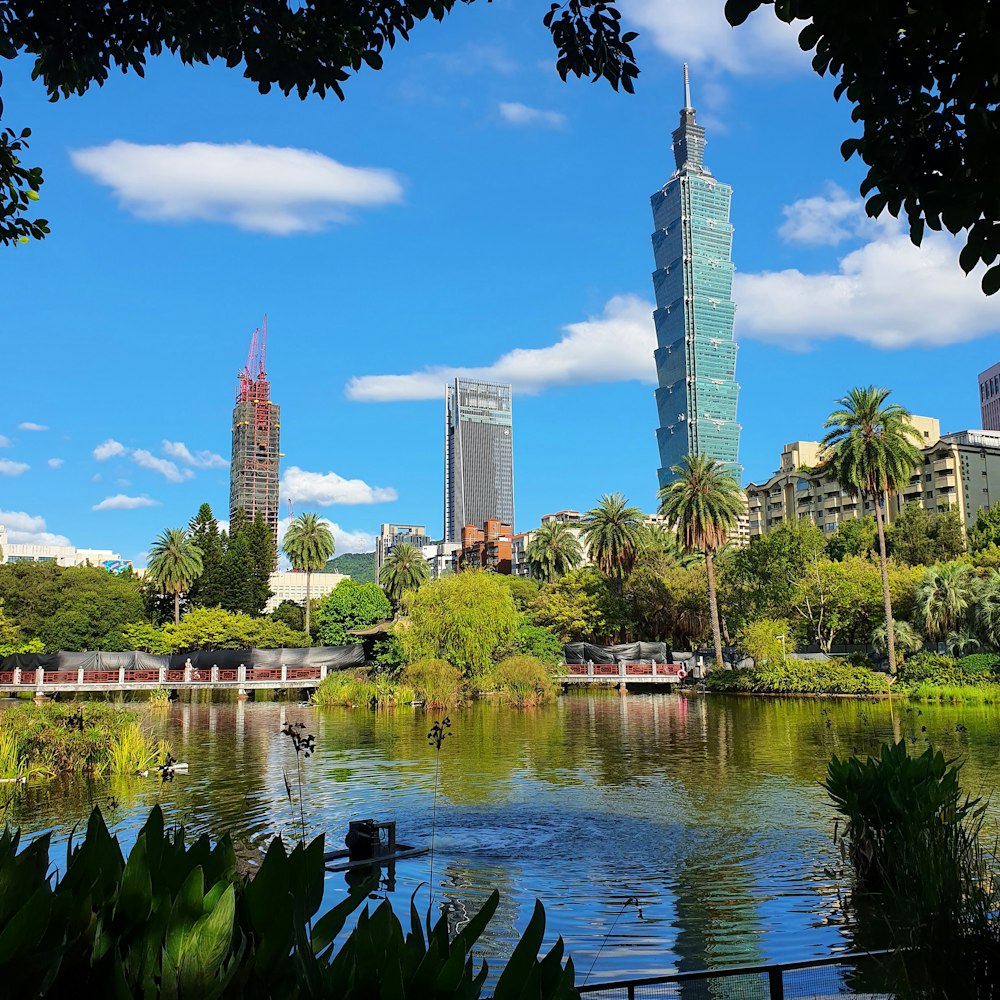 a body of water with trees and buildings around it