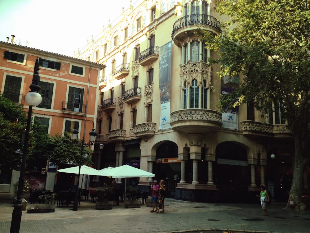 a group of people walking on a street next to a building