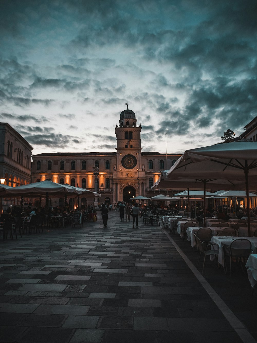 a large building with tables and chairs outside