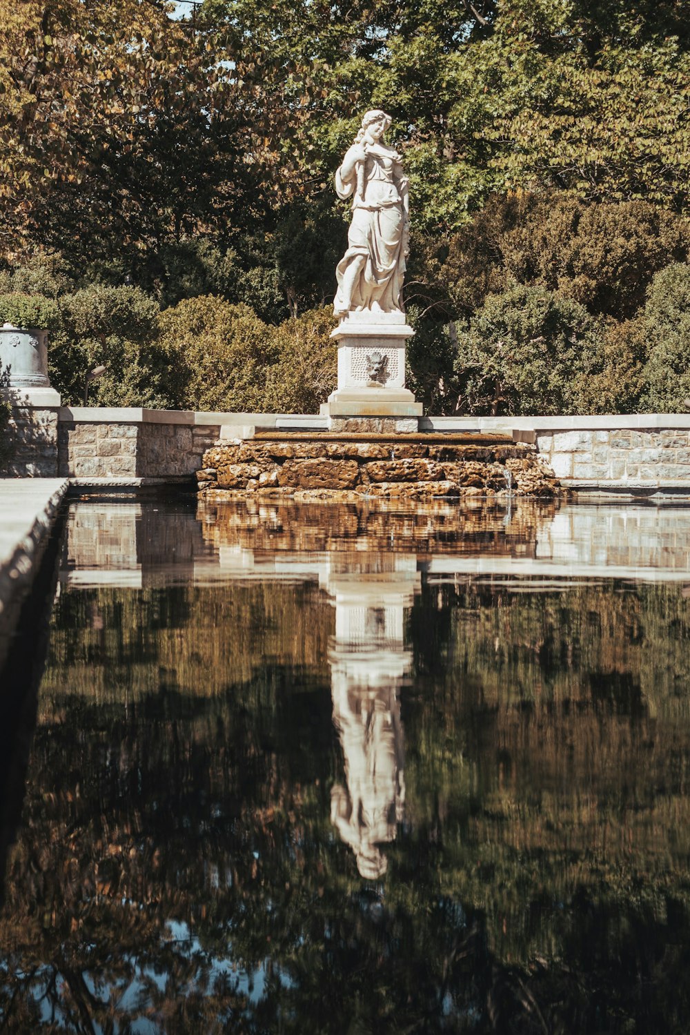 a statue on a stone wall