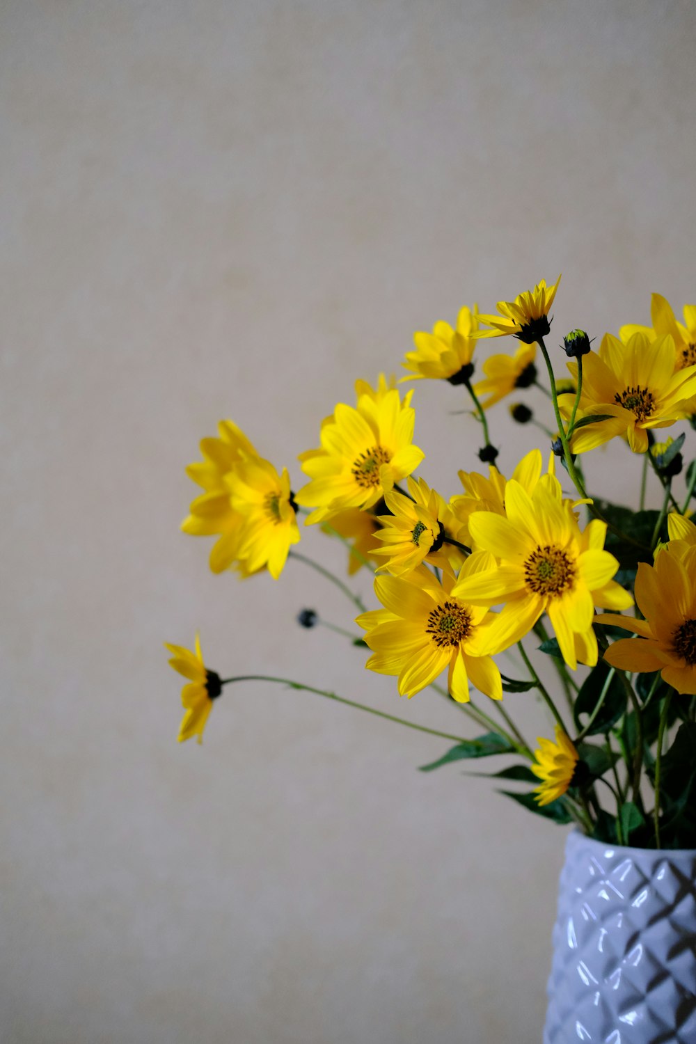 a vase with yellow flowers