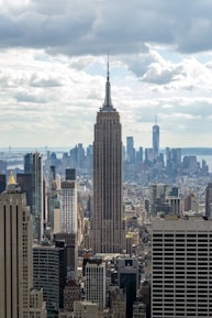 A professional reviewing real estate documents with a city skyline in the background.