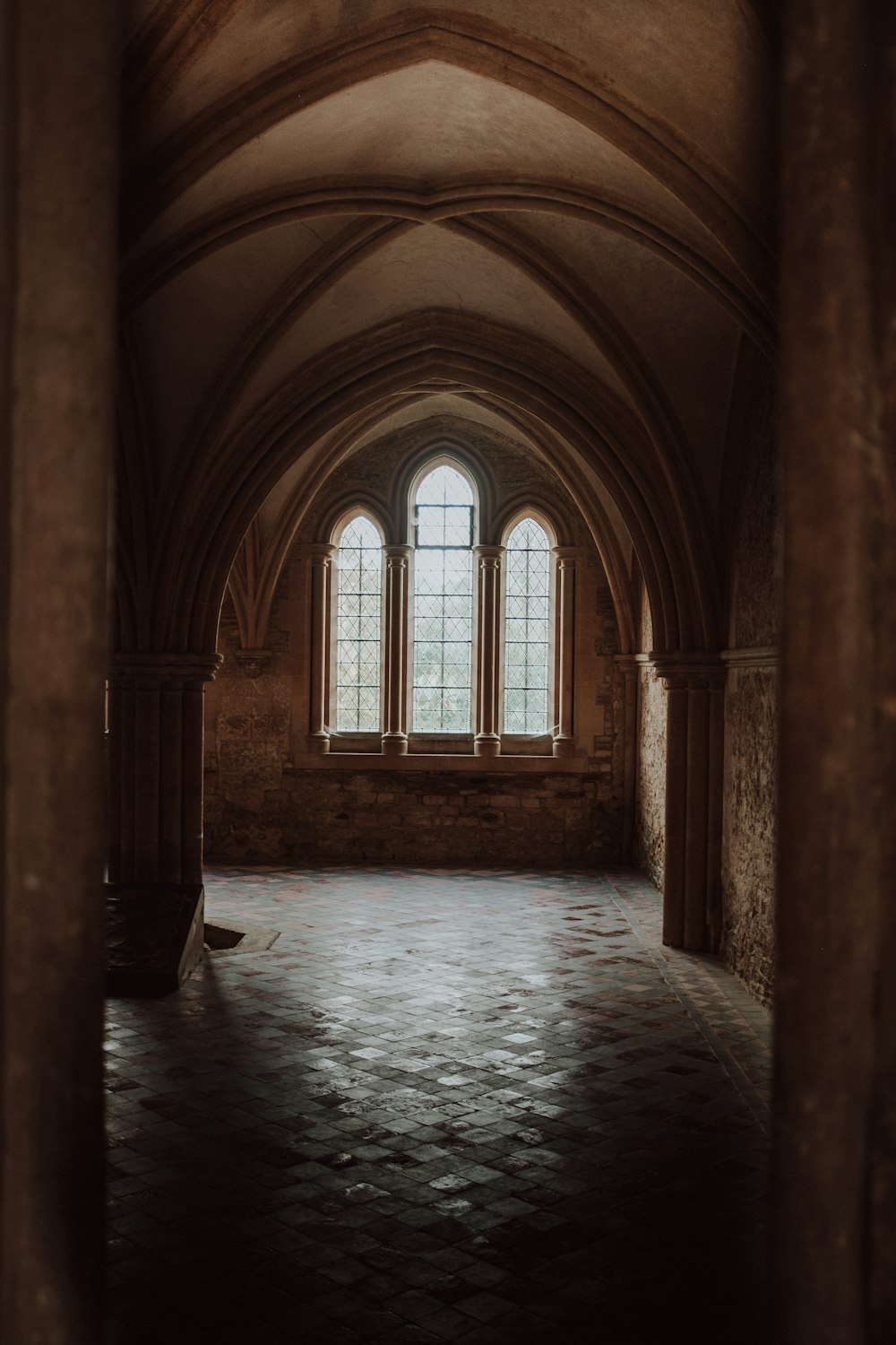 a large arched window with a pool of water in it