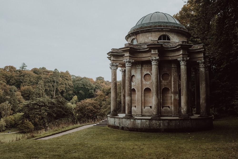 a stone building with columns and a dome on top