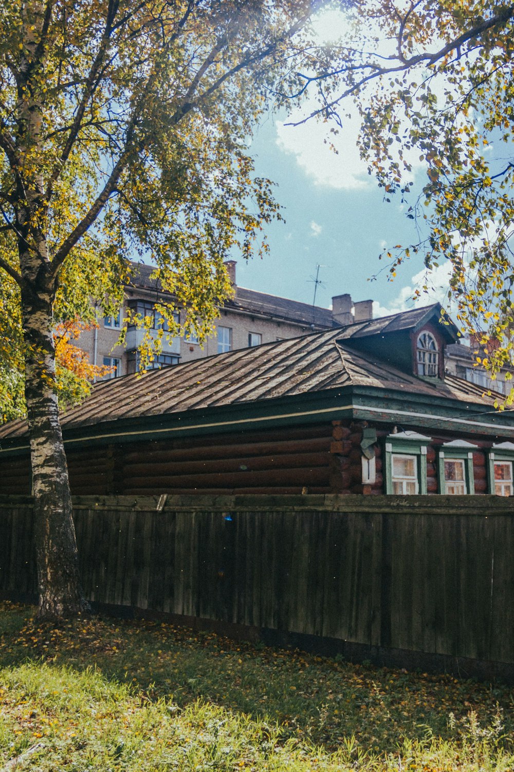 a wooden house with a fence