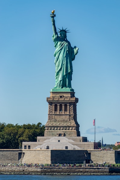 a large statue of a person holding a torch