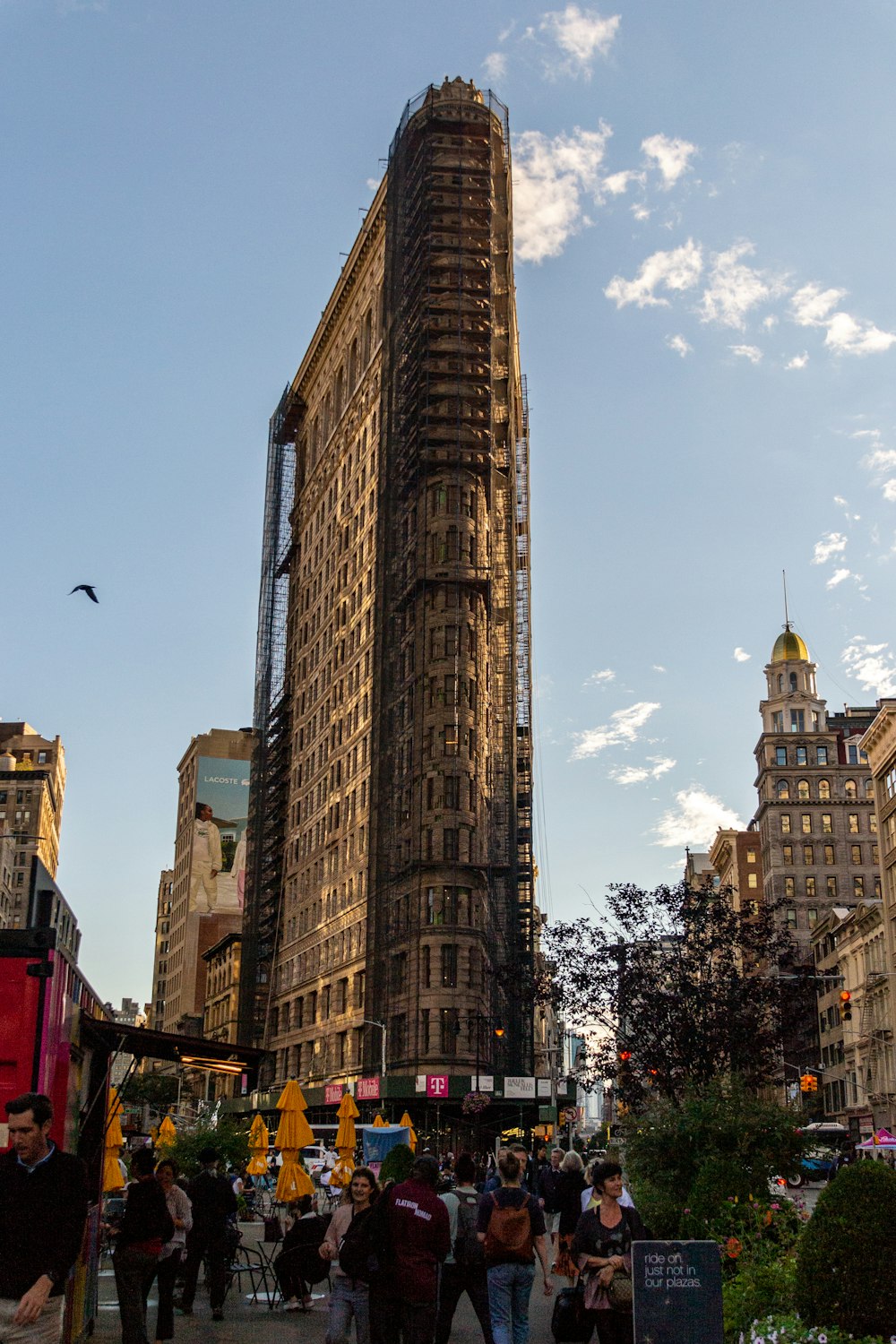 a tall building with many windows with Flatiron Building in the background