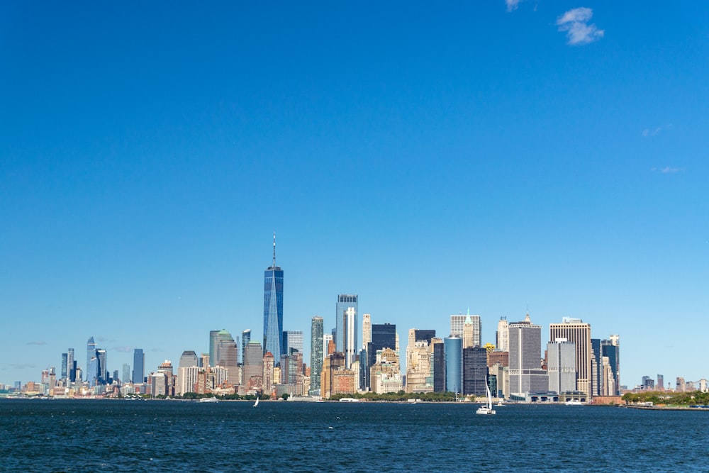 a city skyline with a body of water in the foreground