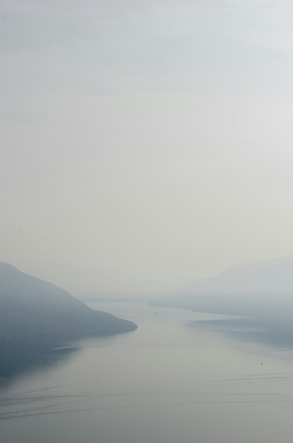 a body of water with hills in the background