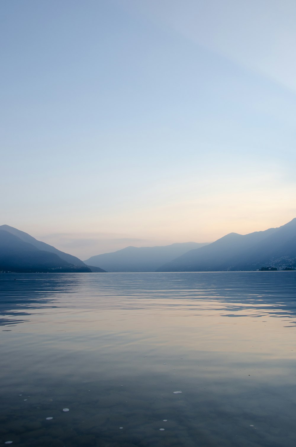 a body of water with mountains in the background