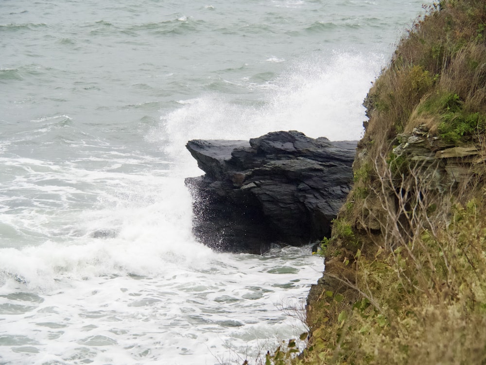 a rocky cliff next to the ocean