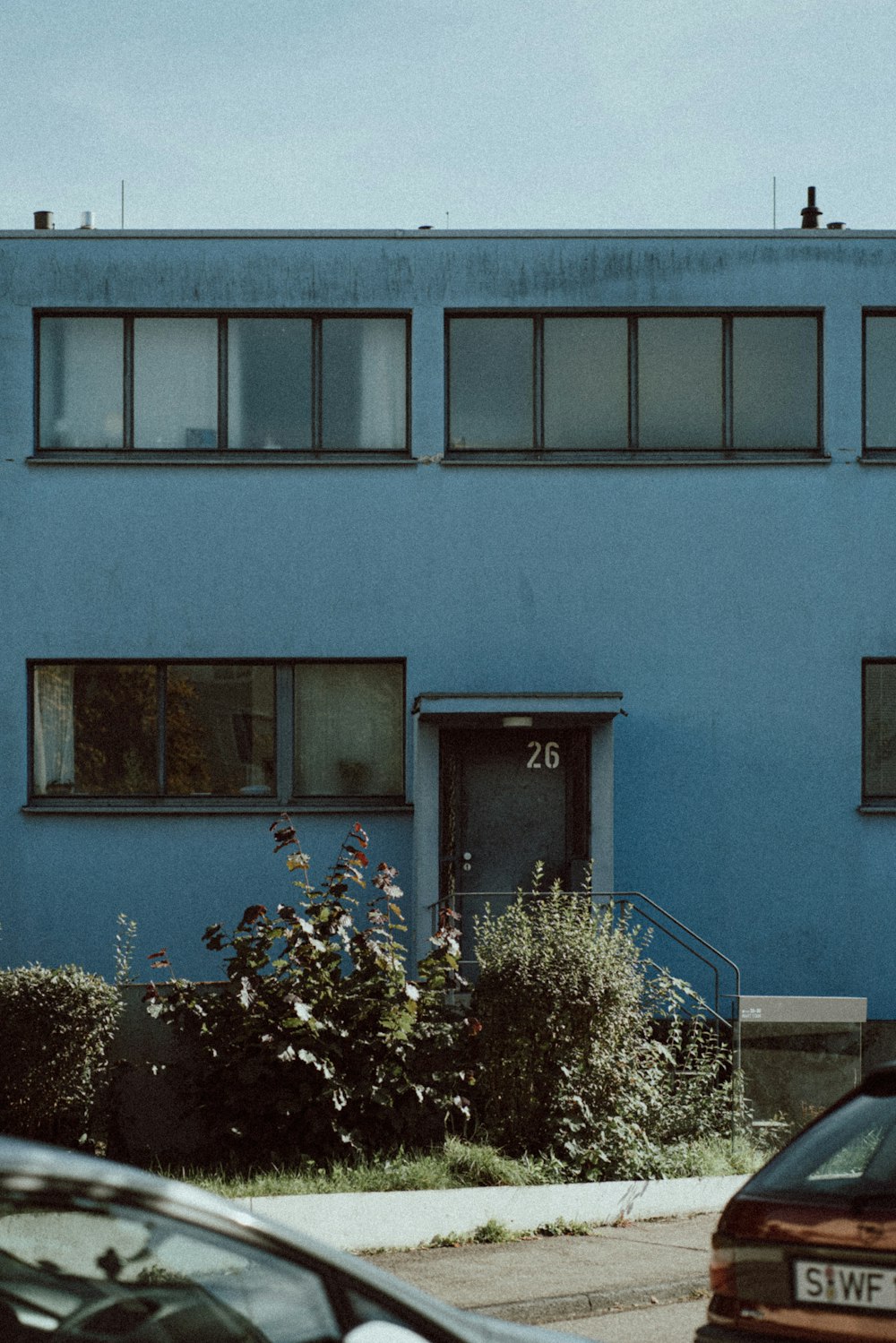 a blue building with a door and windows