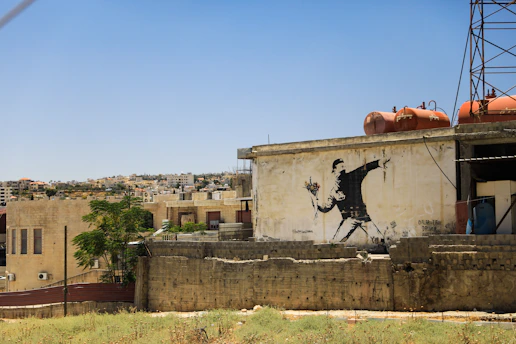 a wall with a mural on it by banksy