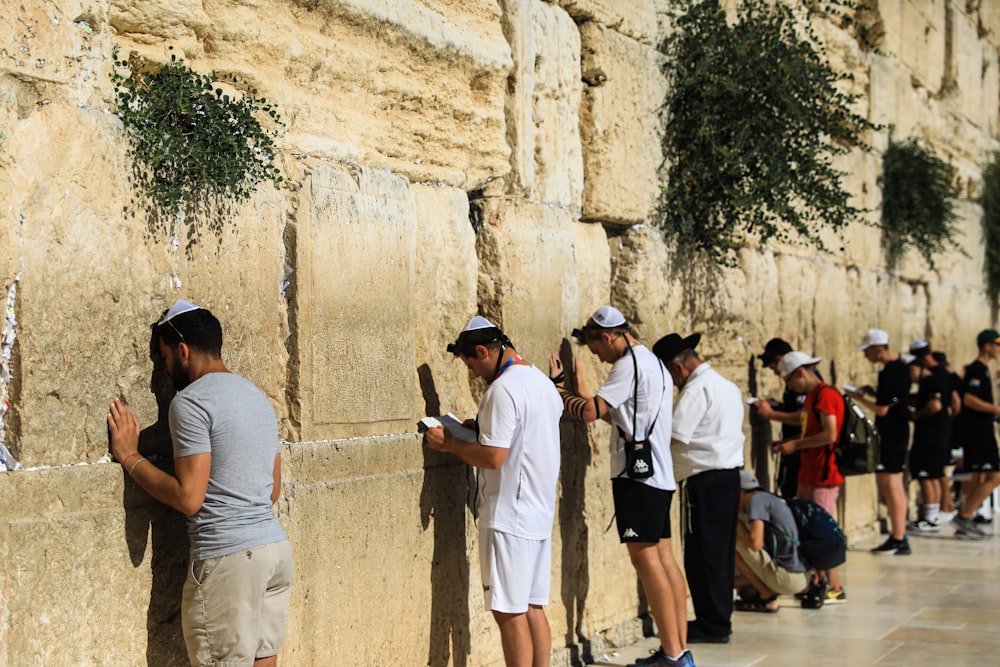 a group of people standing outside with Western Wall in the background