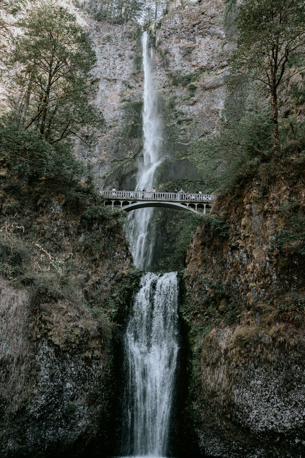 a bridge over a waterfall