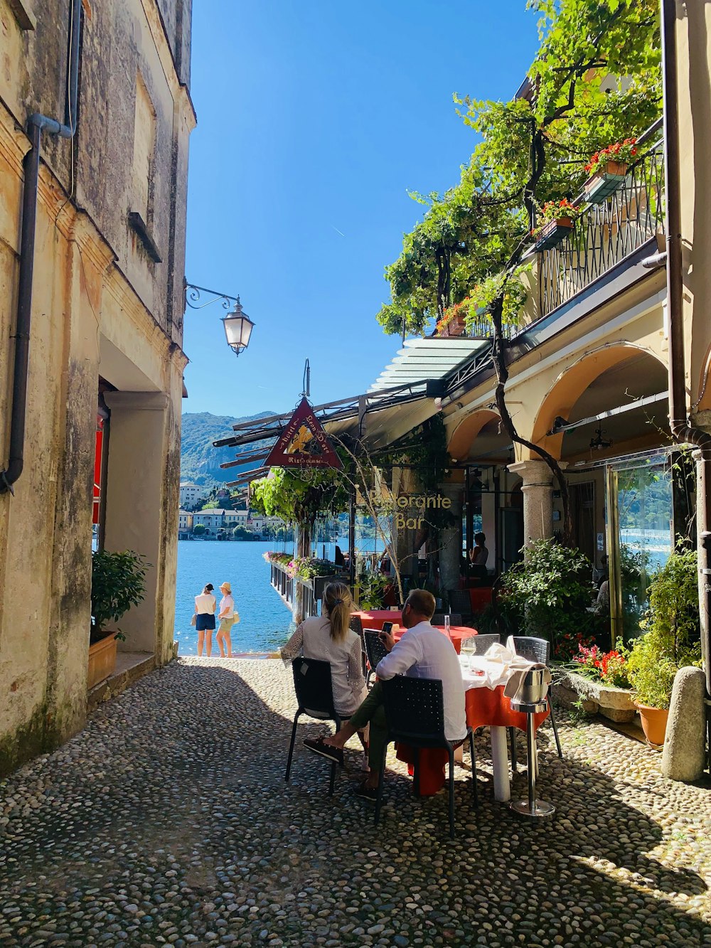 a group of people sitting at a table in a street