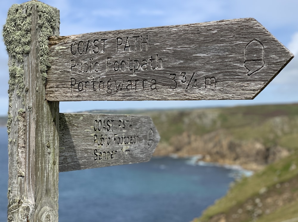 a wooden sign with writing on it