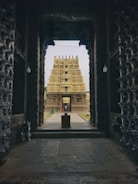 a stone archway with a building in the background