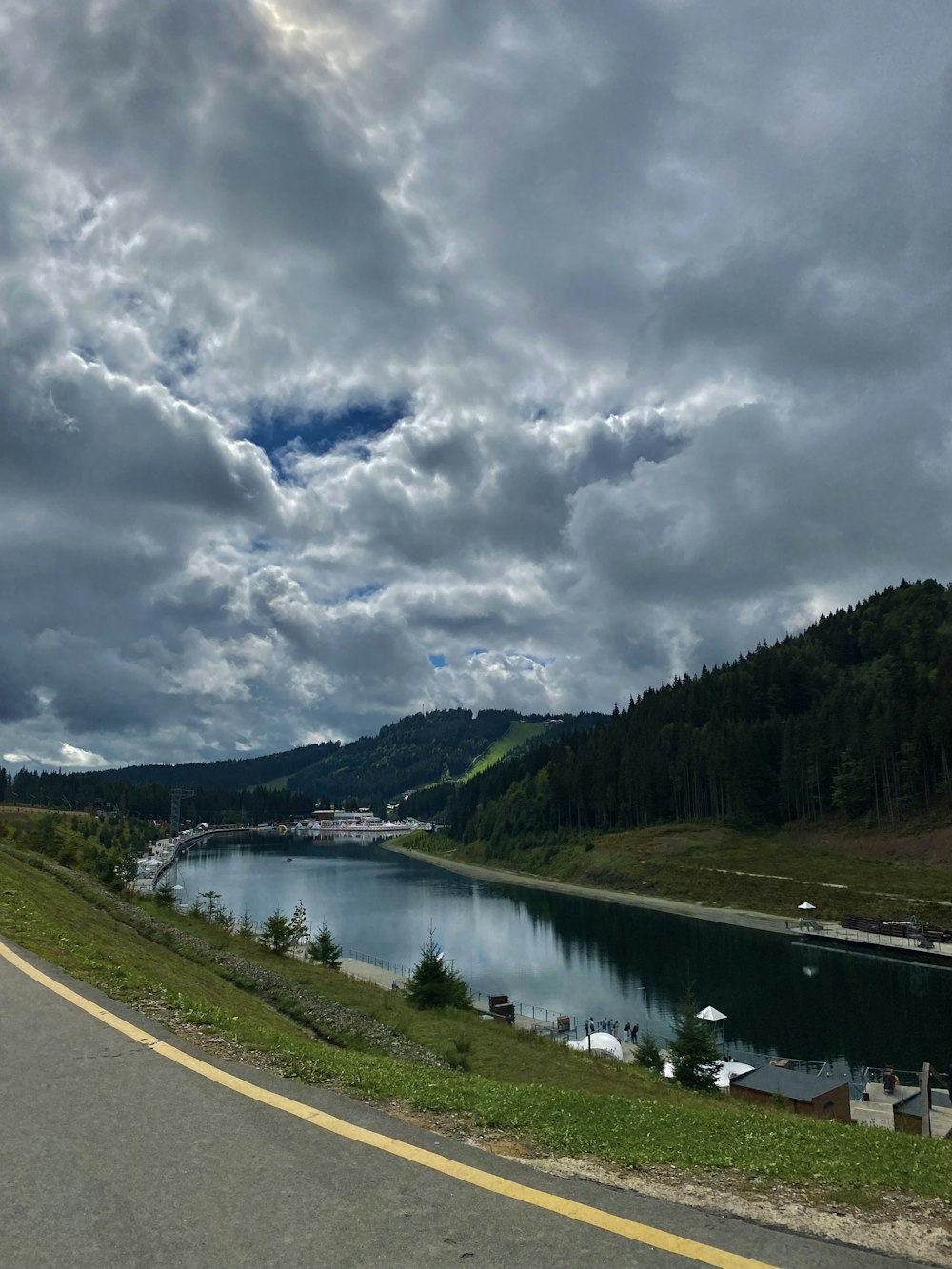 a river with a road and trees on the side