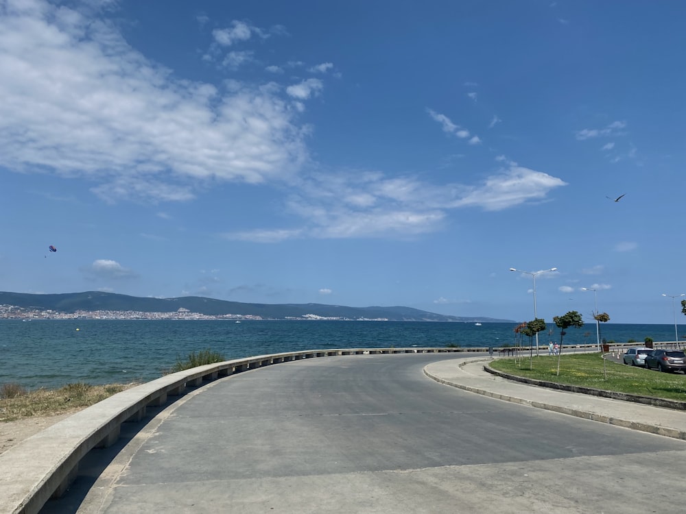 a road next to a body of water