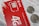 A close-up of a red SIM card holder from MTS with its accompanying packaging. The card displays '4G LTE' and includes a microchip design. Two coins are placed on top of a printed document, partially obscuring the text in Russian.