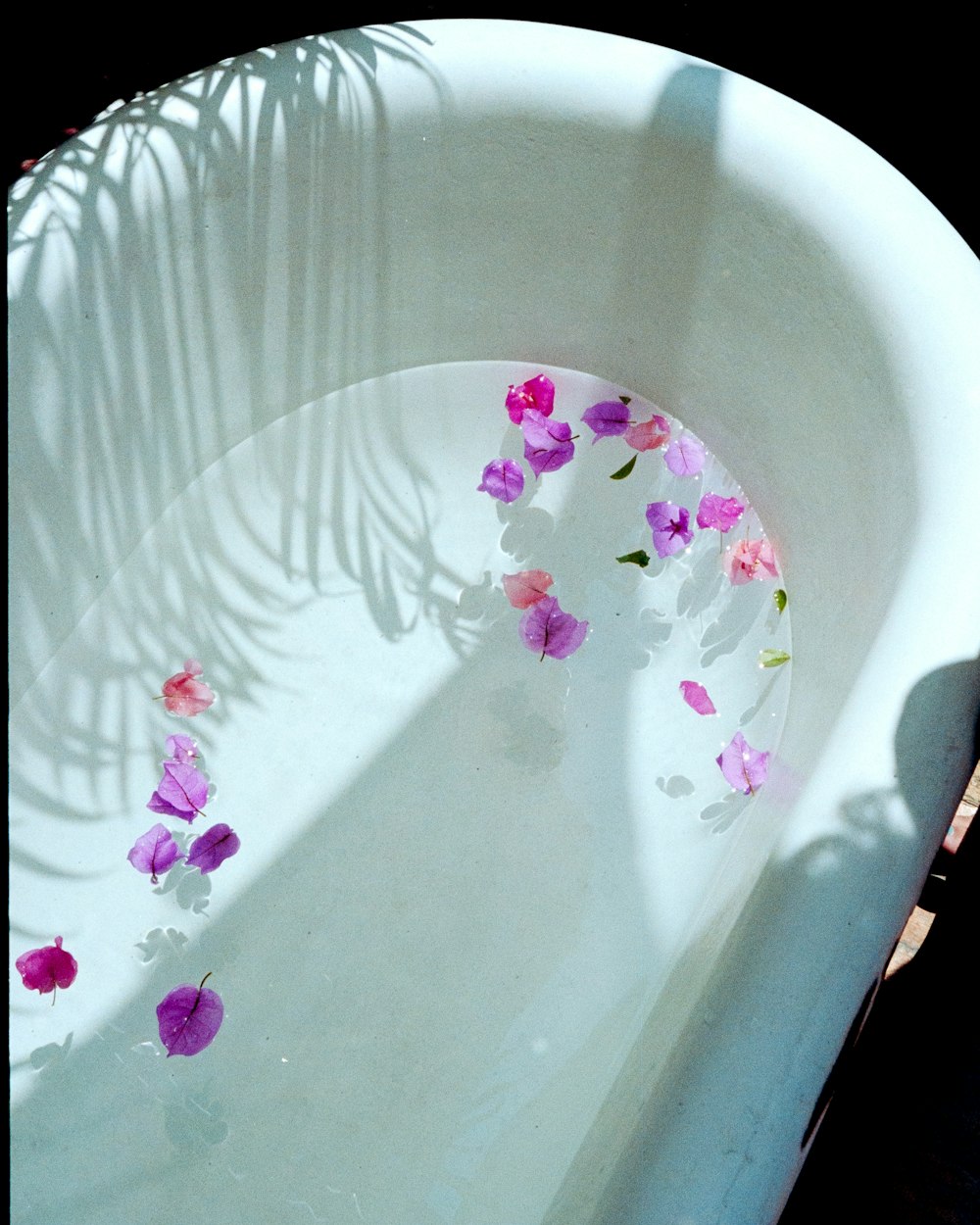 a white bowl with flowers in it