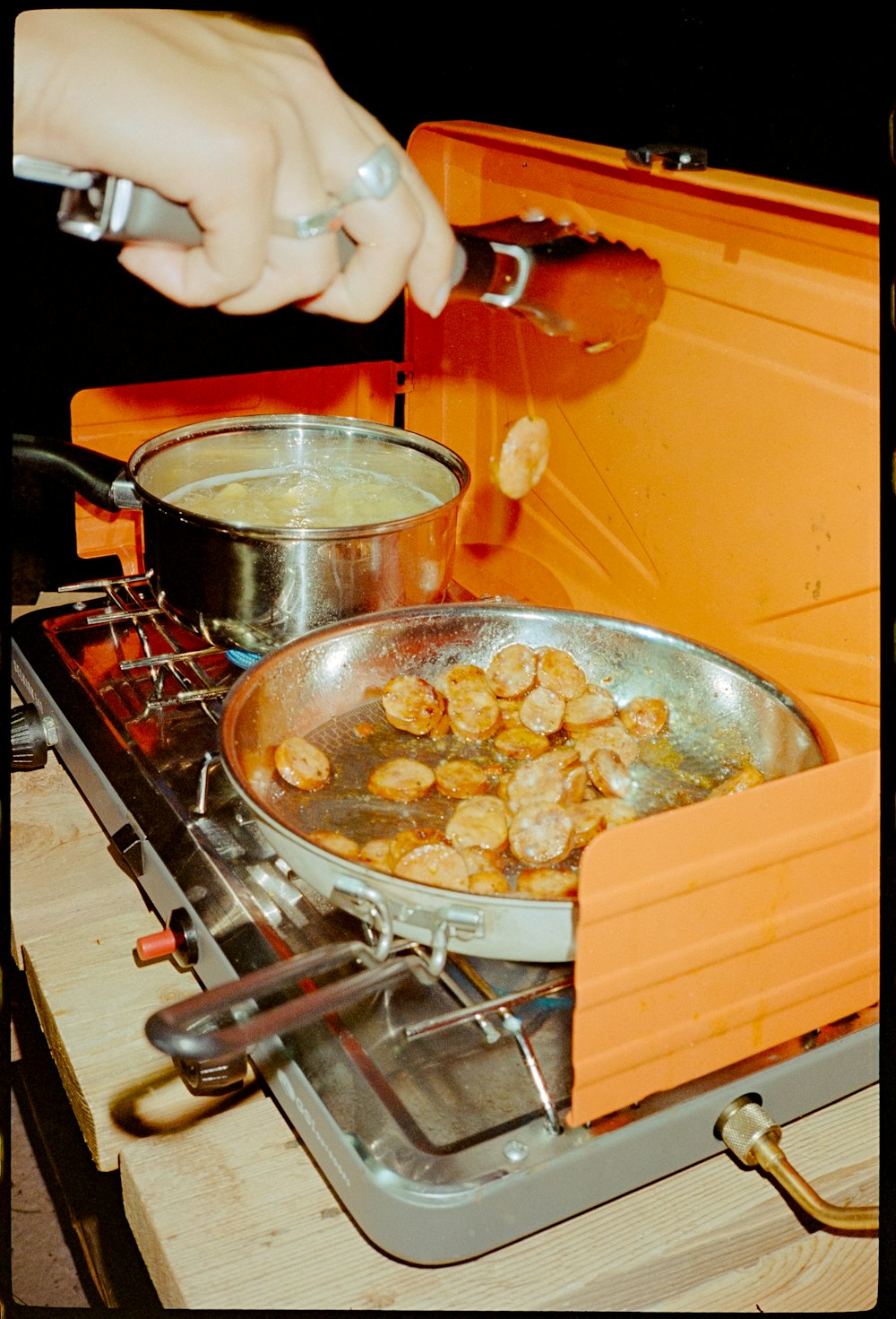 a person cooking food in a pan
