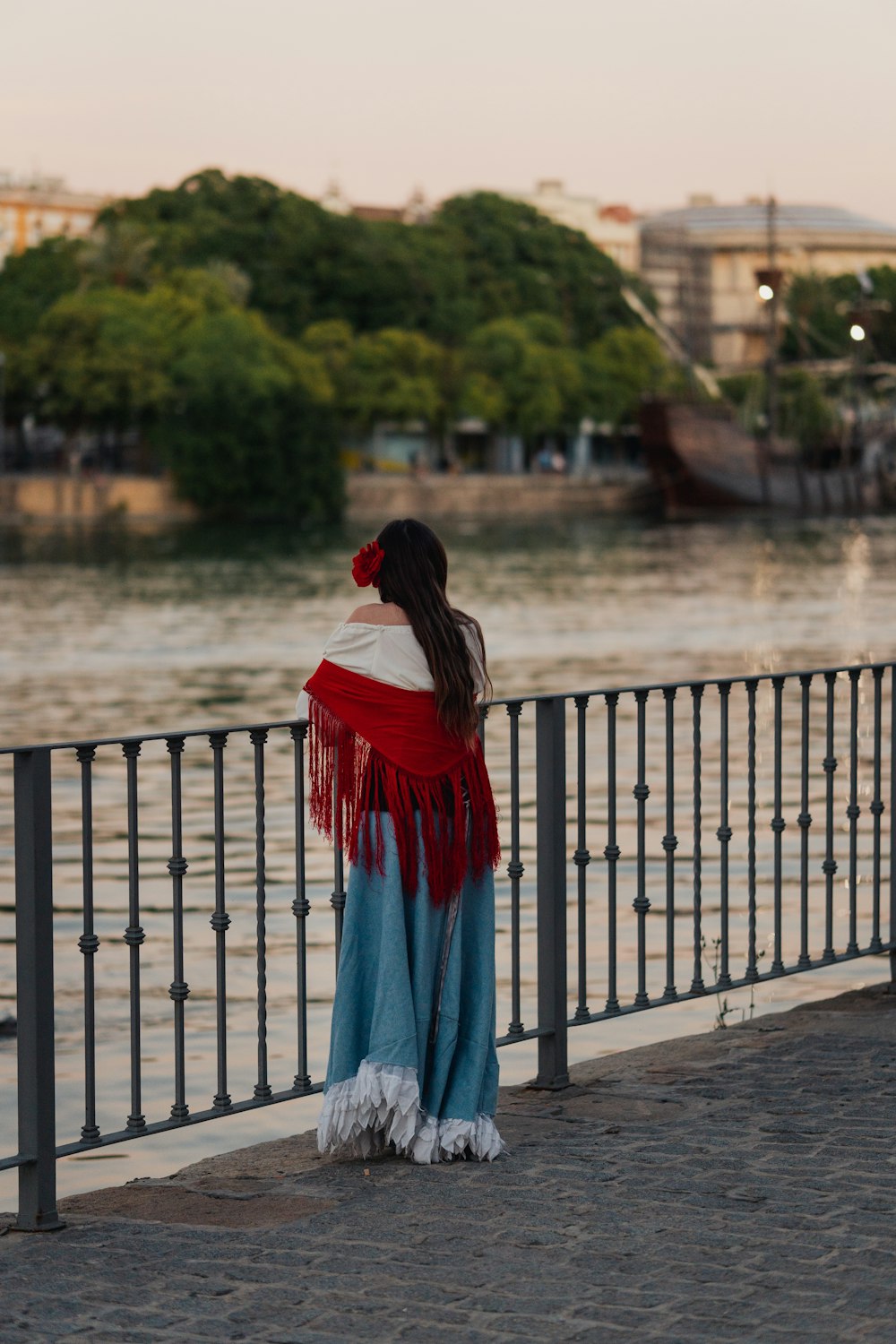 a person standing on a bridge over water