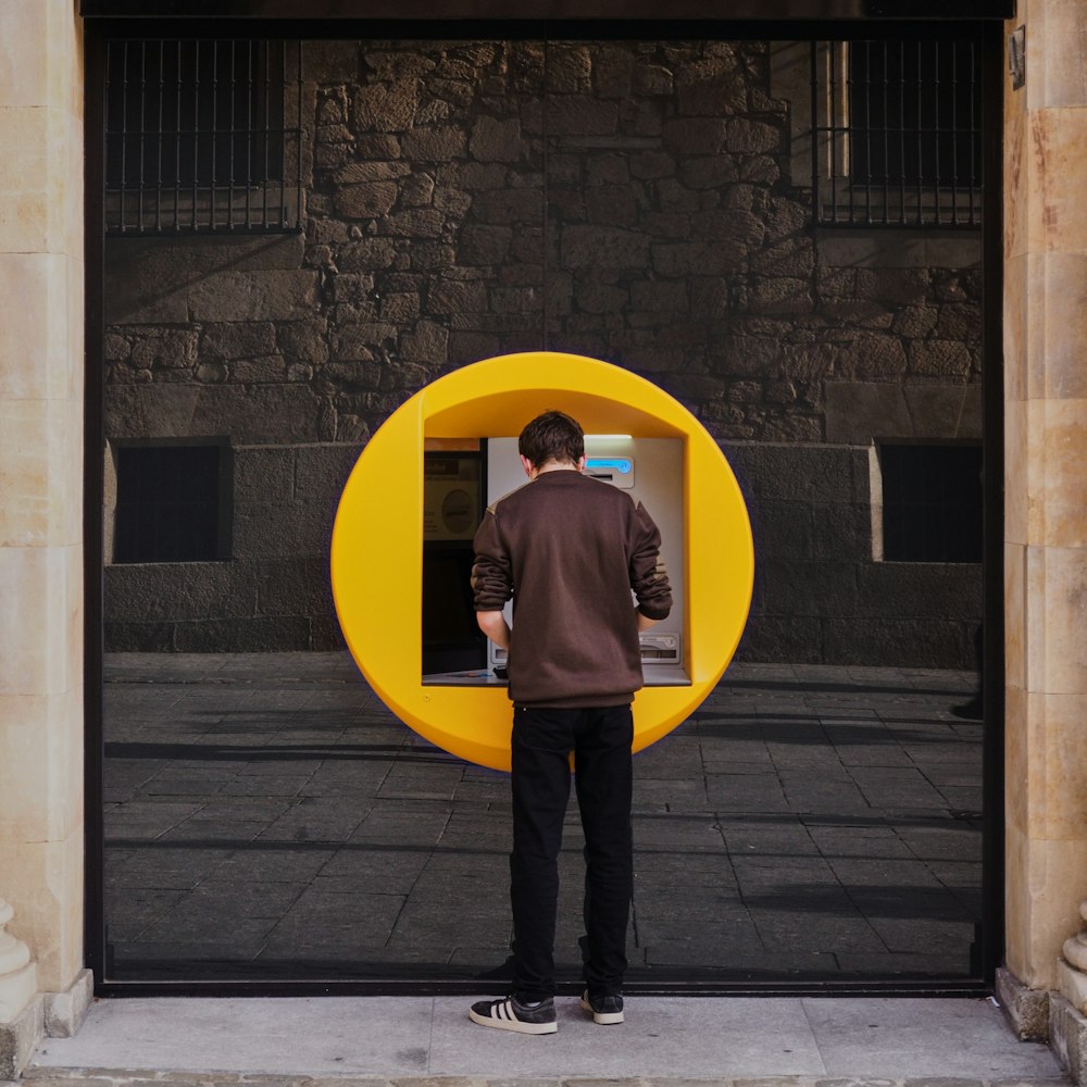 a person standing in front of a yellow door