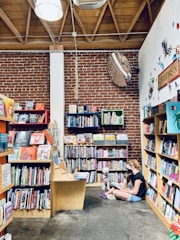 A cozy bookstore corner with a small crowd gathered for a book reading.