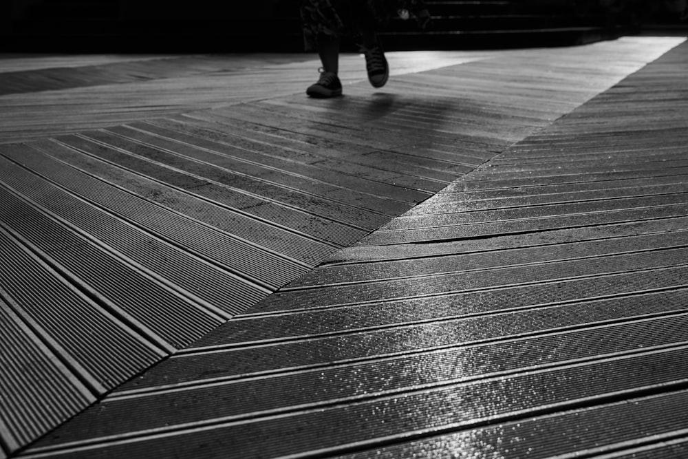 a person walking on a wooden floor